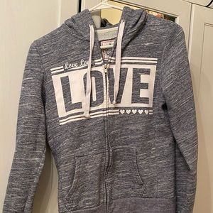 Bluish gray zip up hoodie.